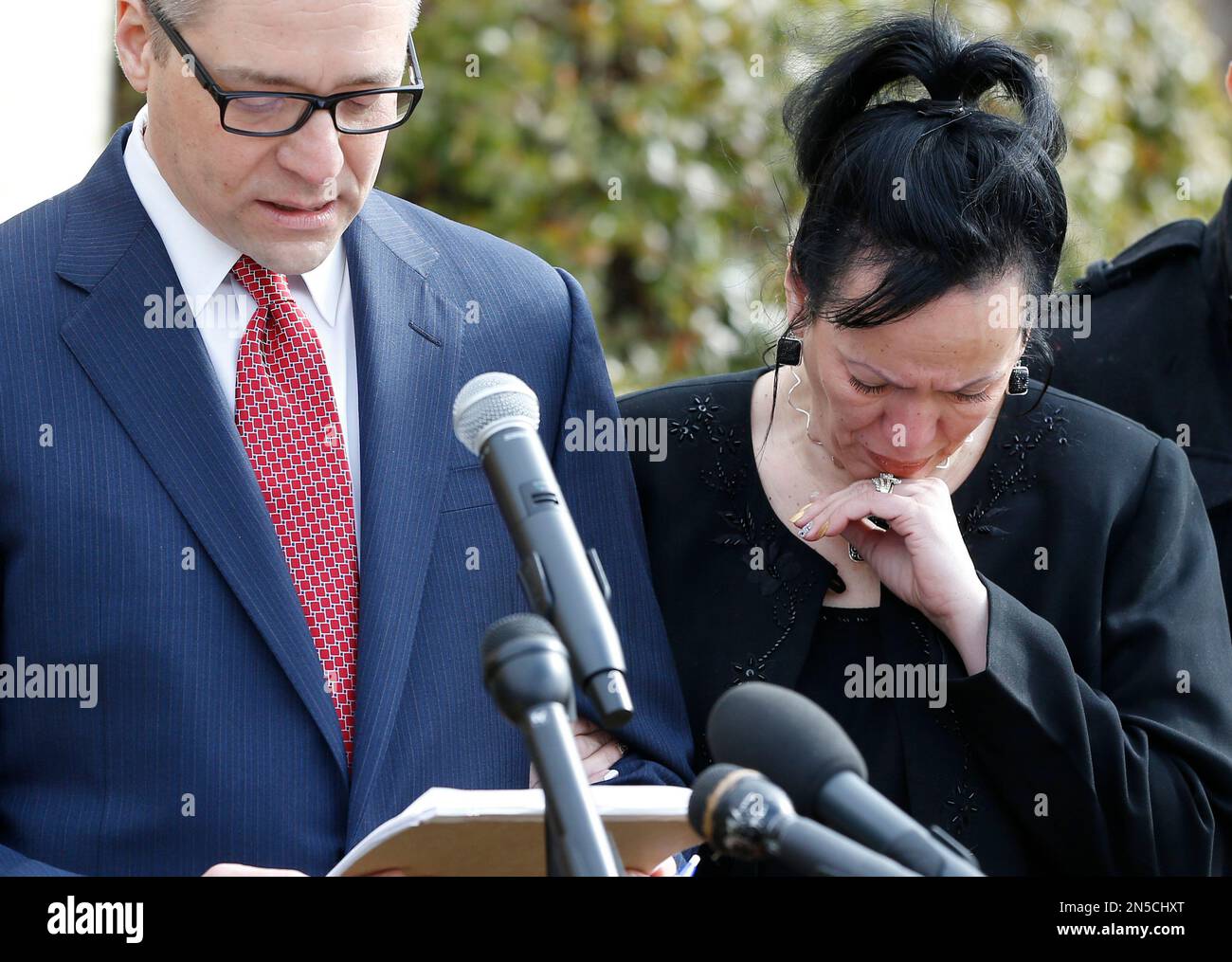 Attorney Michael Brooks-Jimenez, left, speaks at a news conference in  Oklahoma City, Tuesday, Feb. 25, 2014. At right is Nair Rodriguez. At the  news conference, the family of Luis Rodriguez, a man