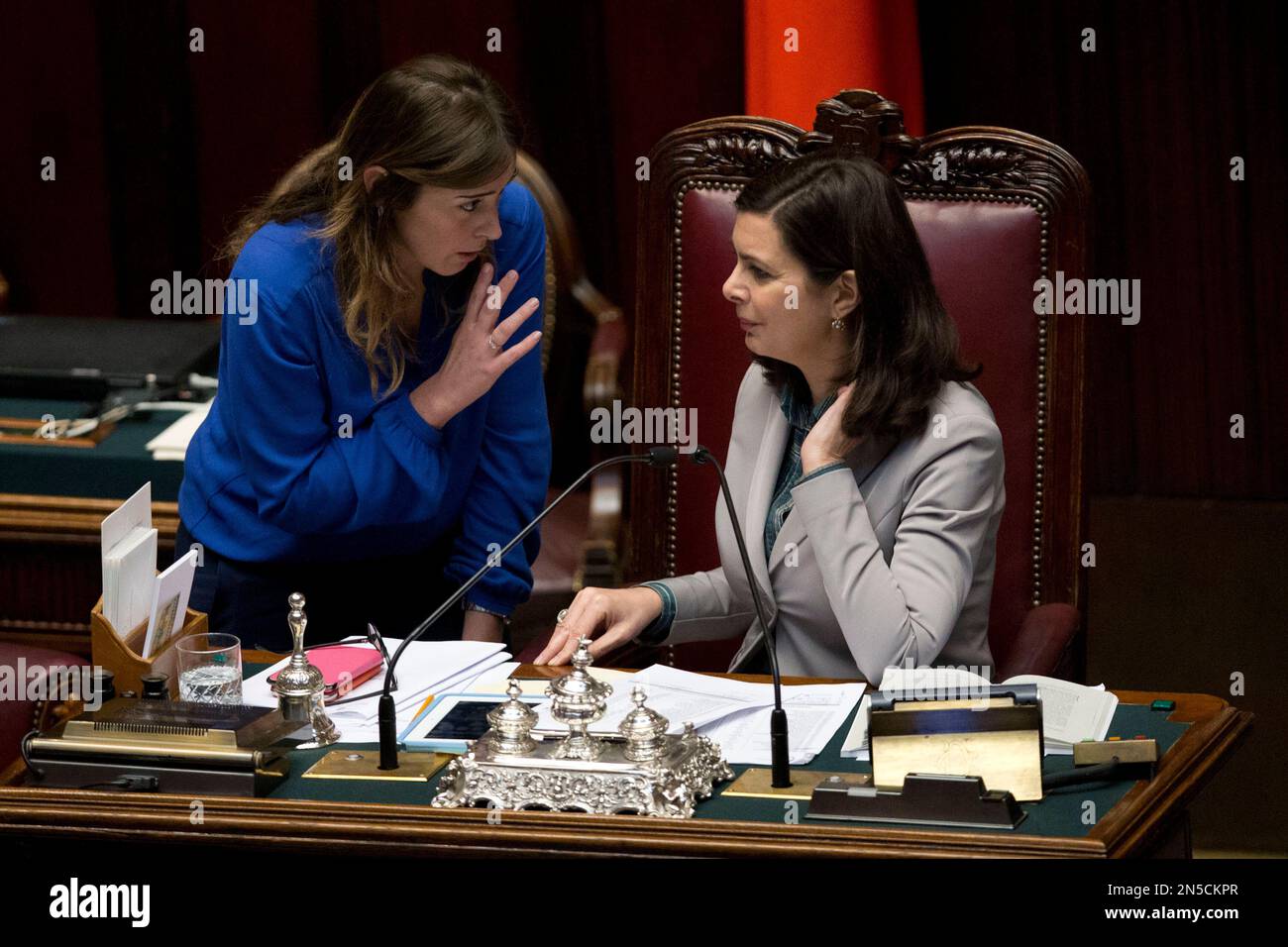 Relations with Parliament Minister Maria Elena Boschi, left, talks with Lower Chamber spokeswoman Laura Boldrini prior to a confidence vote in the Chamber of Deputies, in Rome, Tuesday, Feb. 25, 2014. The Senate voted 169-139 to confirm Premier Matteo Renzi's broad coalition, which ranges from his center-left Democrats to center-right forces formerly loyal to ex-premier Silvio Berlusconi. Renzi needed at least 155 votes to clinch the victory, one of two mandatory confidence votes. The second vote, in the Chamber of Deputies, is expected later Tuesday. Renzi's coalition has a comfortable majori Stock Photo