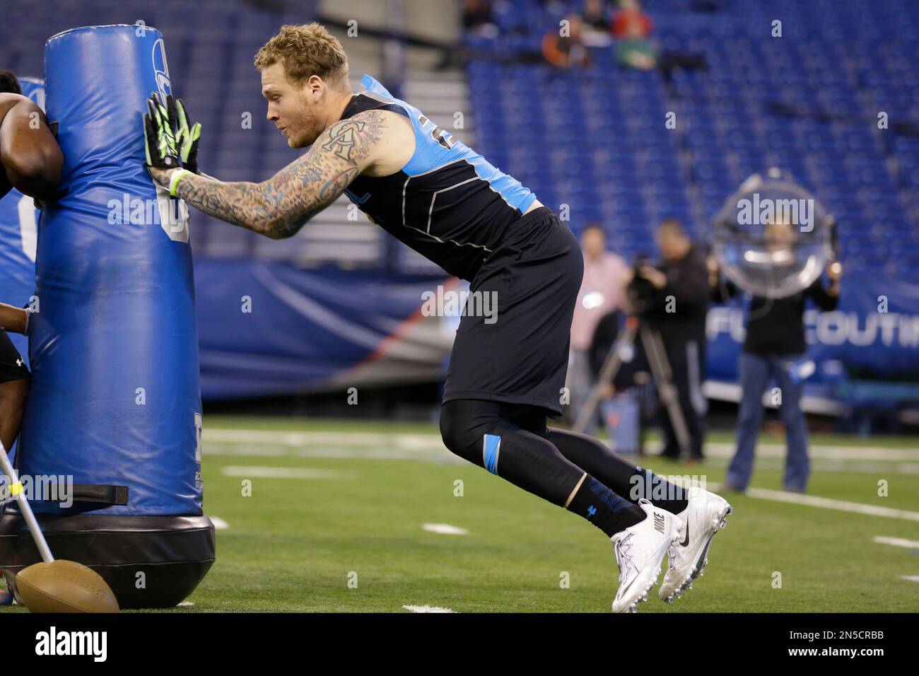 UCLA defensive lineman Cassius Marsh runs a drill at the NFL football scouting combine in Indianapolis, Monday, Feb. 24, 2014. (AP Photo/Michael Conroy) Stock Photo