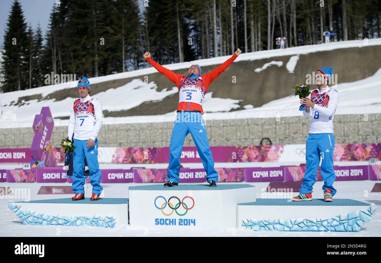 Russia's gold medal winner Alexander Legkov is flanked by Russia's ...