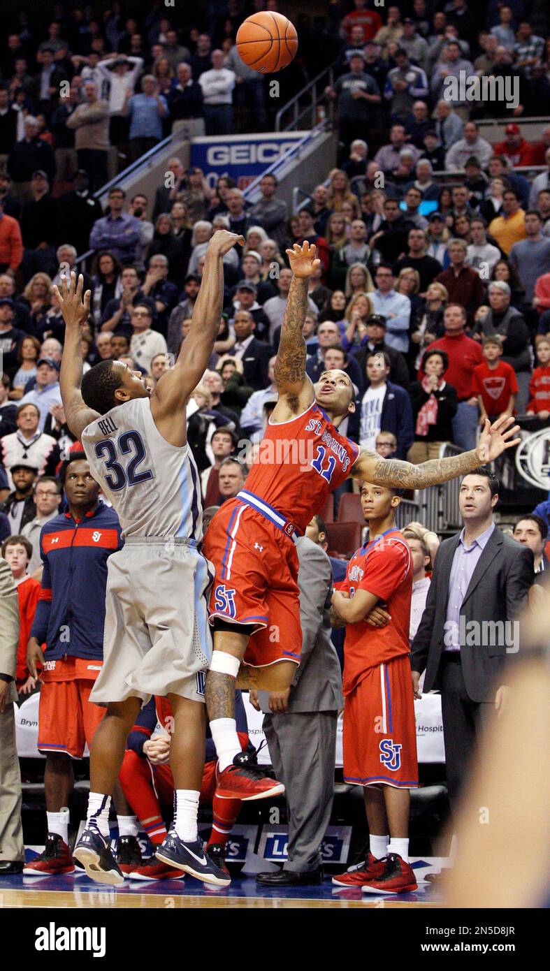 St. John's D'Angelo Harrison, right, shoots while being guarded by ...