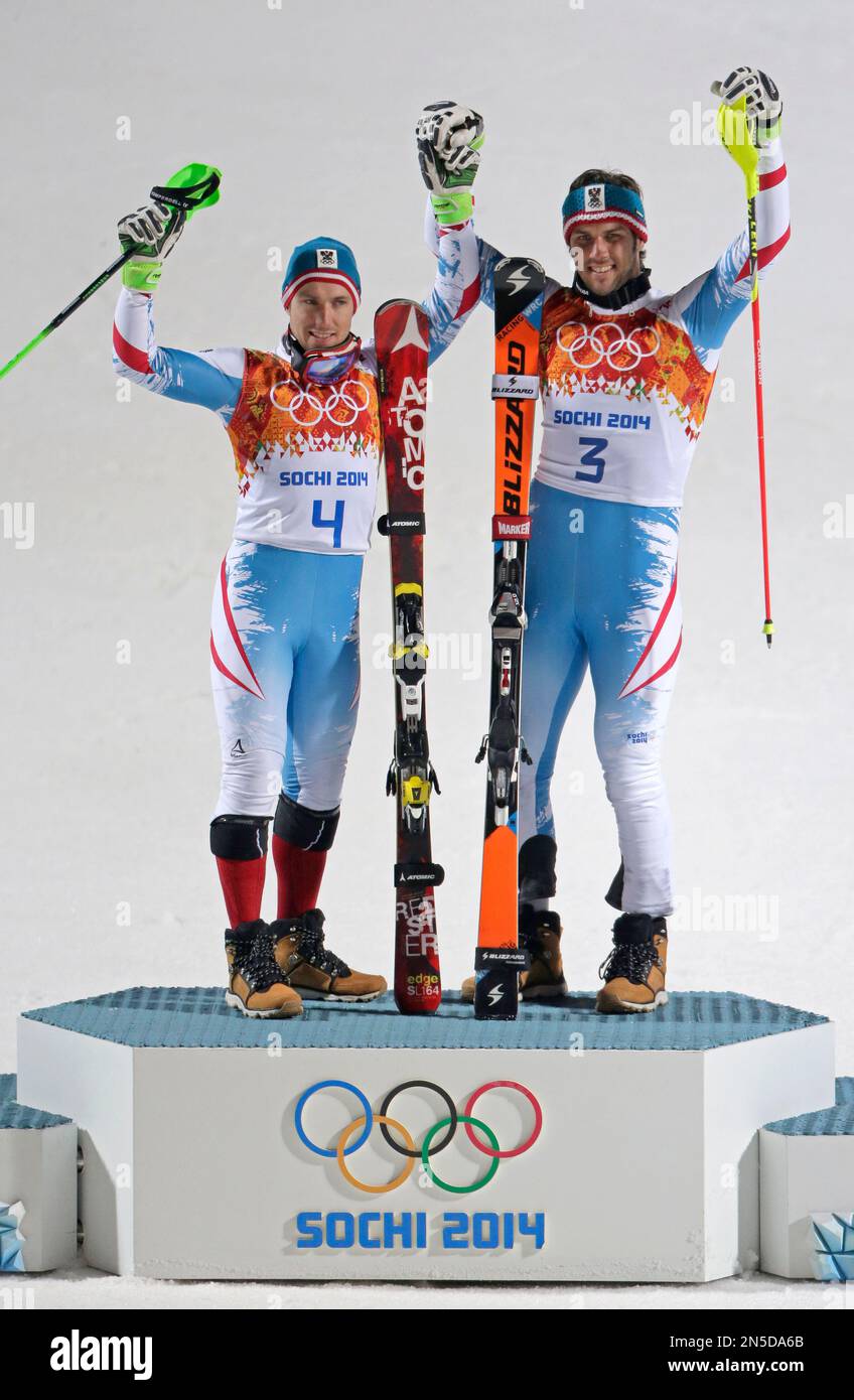 Men's slalom winners Austria's Mario Matt (gold), right, and his teammate  Austria's Marcel Hirscher (silver) celebrate on the podium at the Sochi  2014 Winter Olympics, Saturday, Feb. 22, 2014, in Krasnaya Polyana,