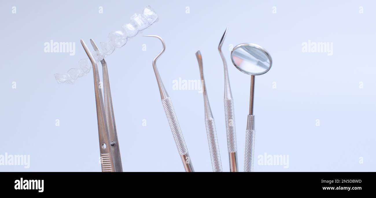 Dental tools and model of teeth on a blue background. Dental care ...