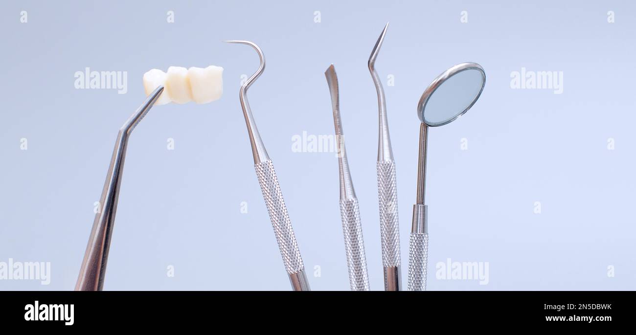 Dental tools and model of teeth on a blue background. Dental care ...