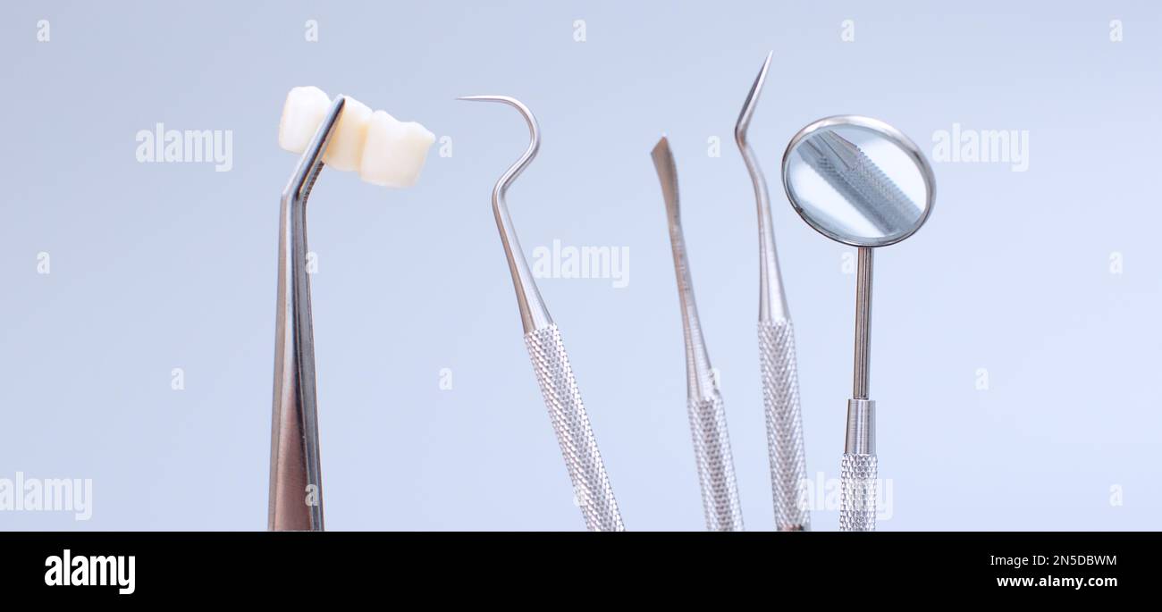 Dental tools and model of teeth on a blue background. Dental care ...