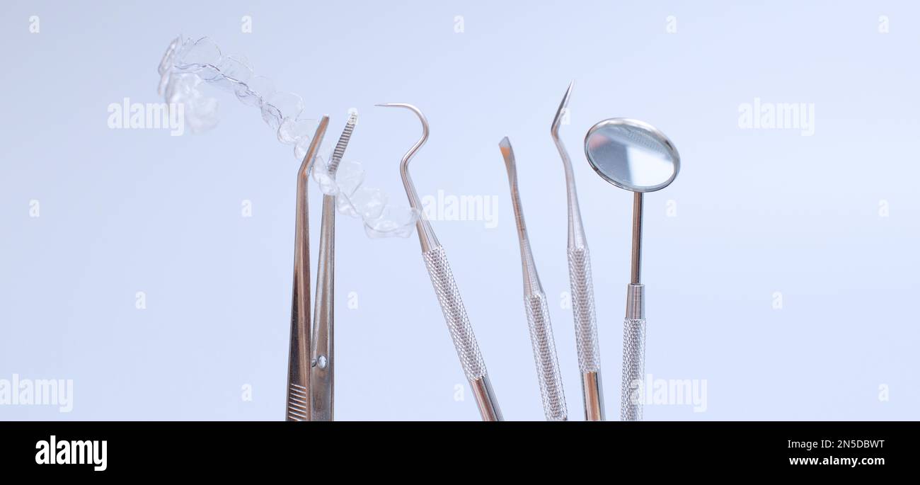 Dental tools and model of teeth on a blue background. Dental care ...