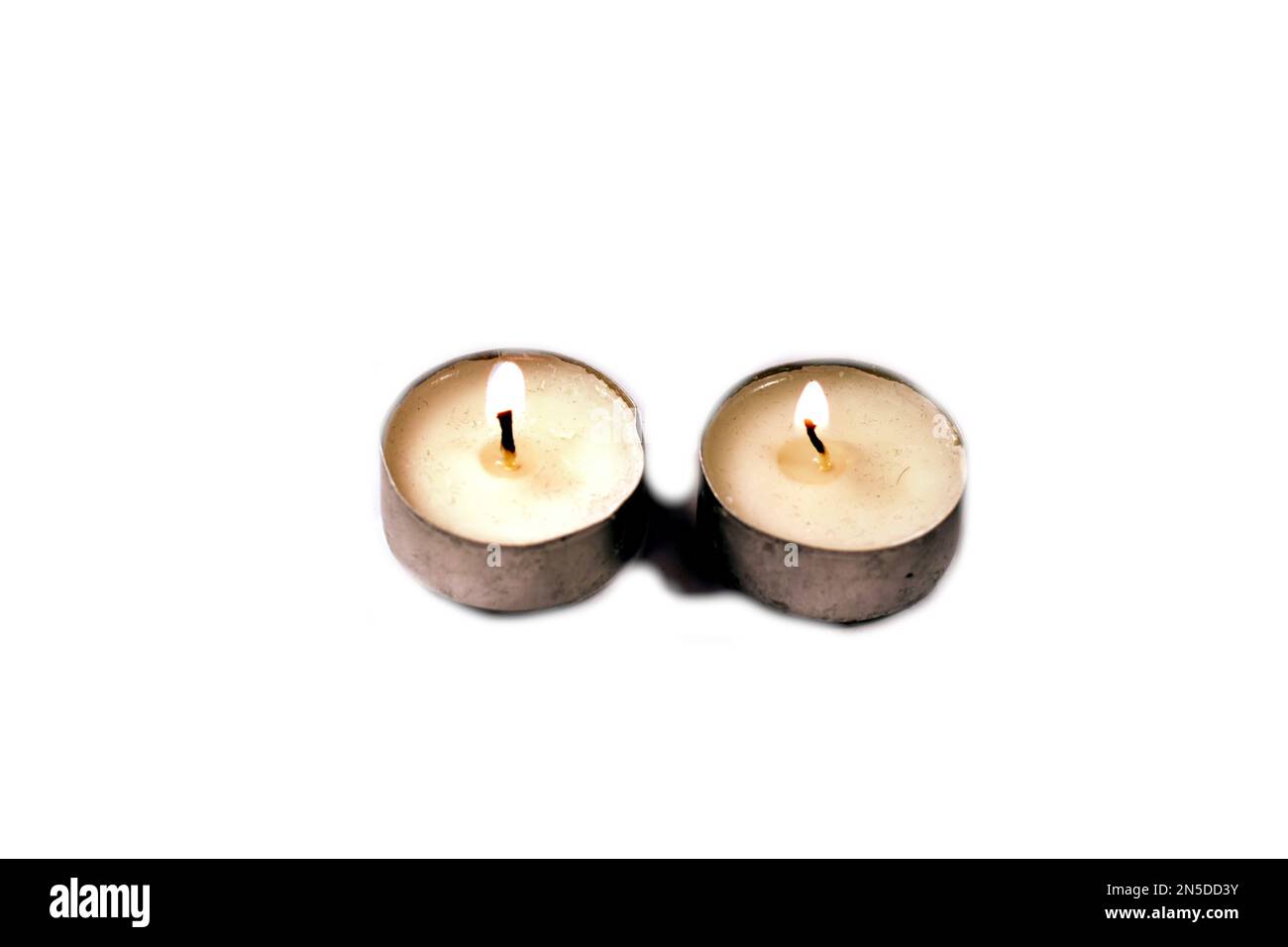 Two candles on a white background Stock Photo - Alamy
