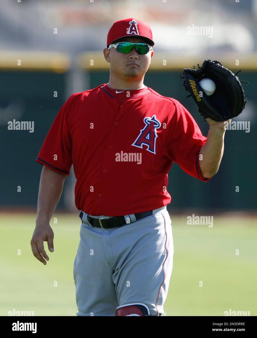 Los Angeles Angels catcher Hank Conger (16) warms up during spring training baseball practice