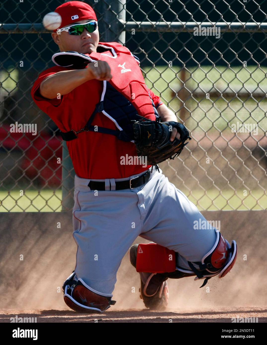Los Angeles Angels catcher Hank Conger (16) fields loose balls during spring training baseball