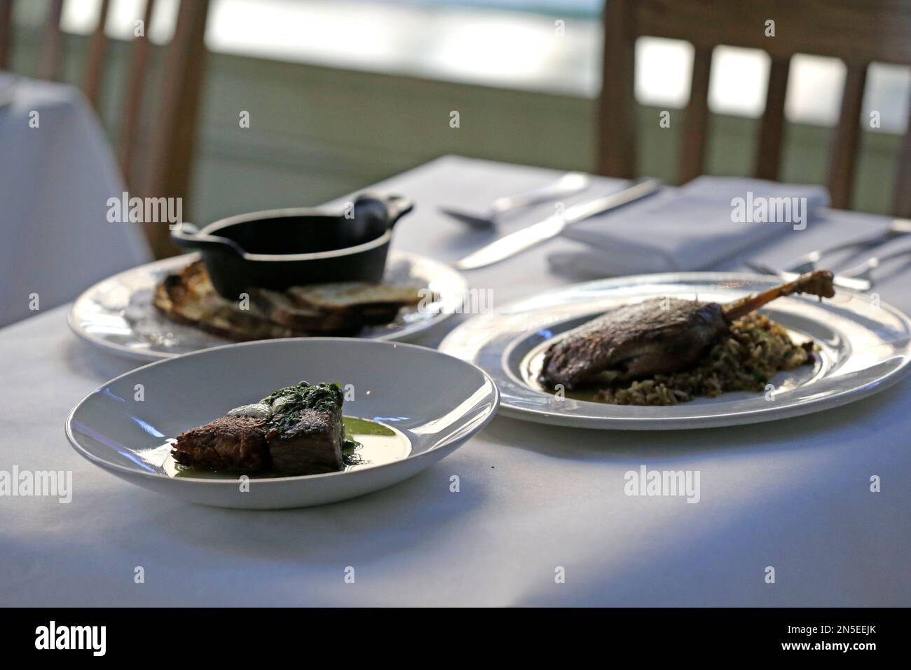 Braised short rib with potato rosti and horseradish cream, foreground