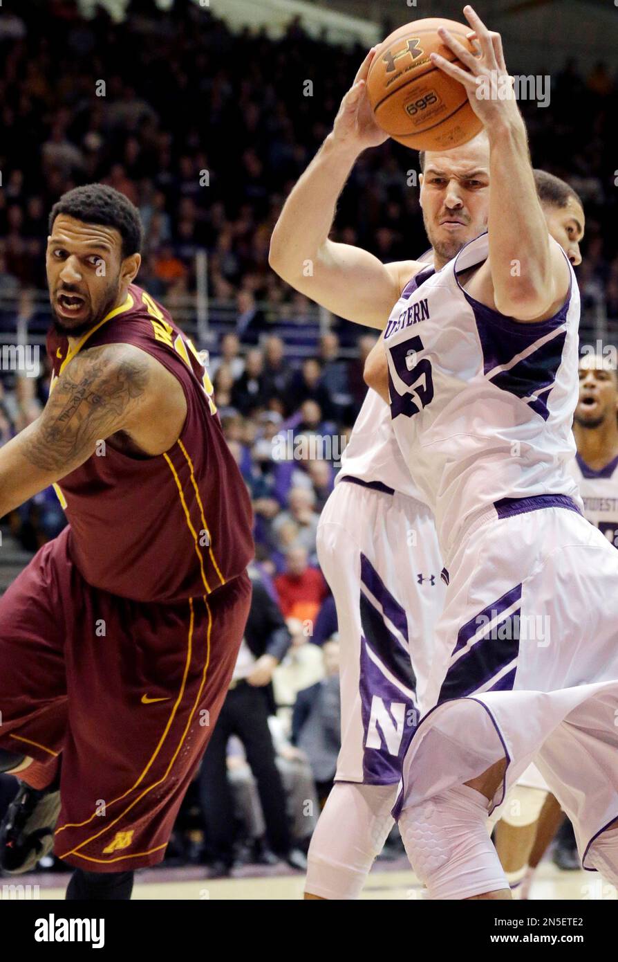 Northwestern forward Nikola Cerina, right, rebounds the ball against