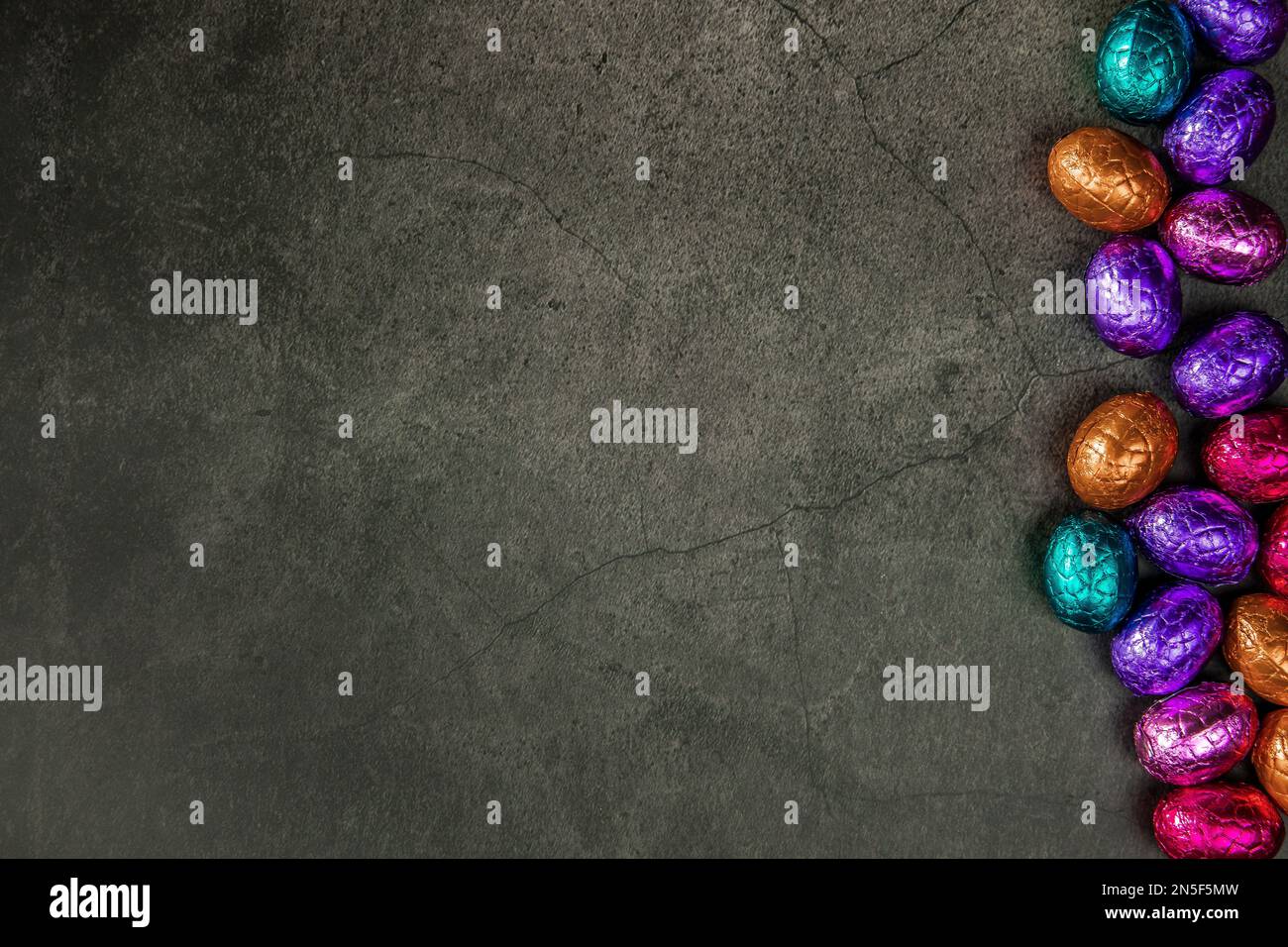 Delicious chocolate easter eggs ,sweets on dark black background,easter ...