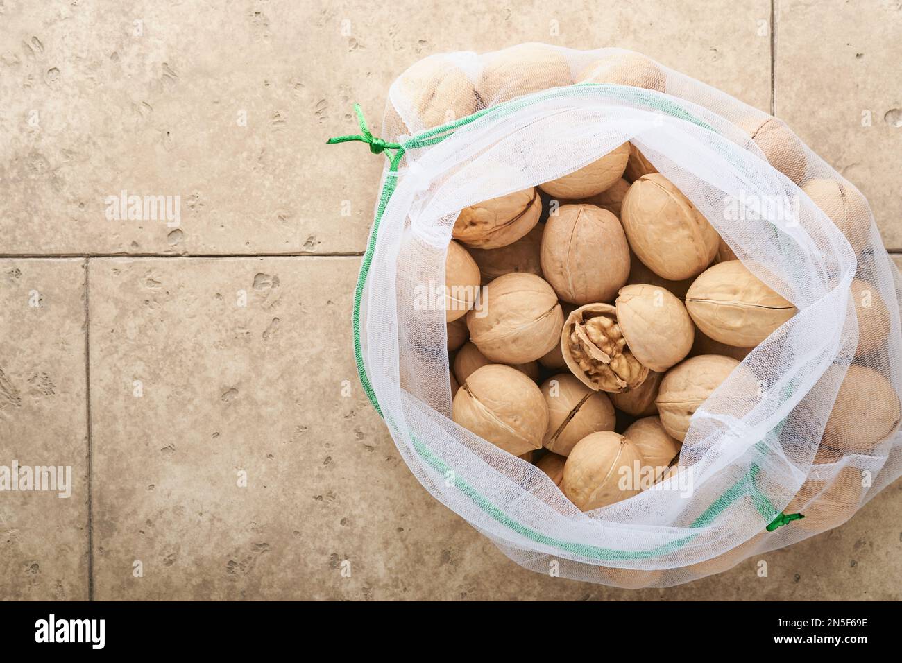 Passover celebration concept. Organic walnuts in eco bags on old grey