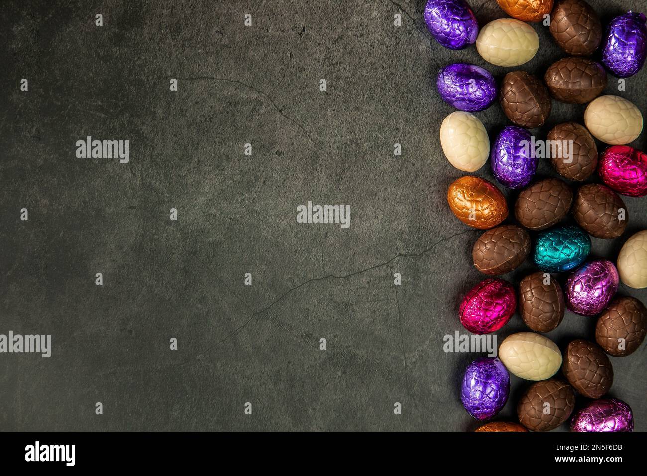 Delicious chocolate easter eggs ,sweets on dark black background,easter ...