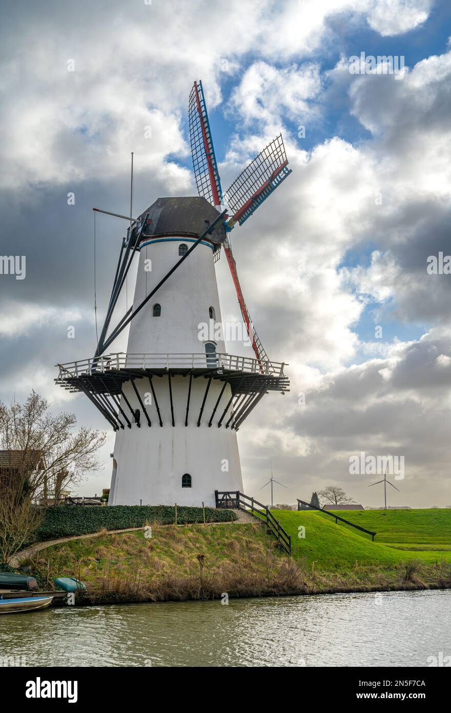 Historical white windmill along the Linge river in the village of Deil, Province Gelderland, The Netherlands Stock Photo