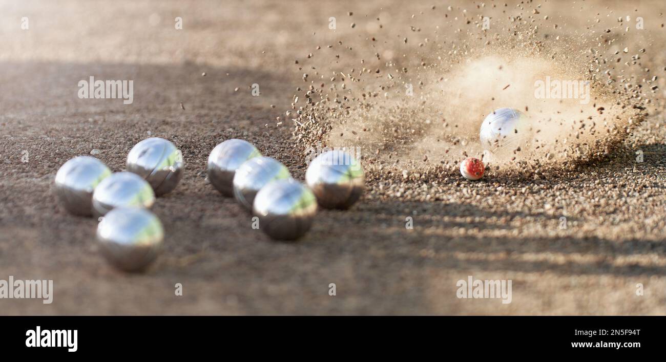 Petanque ball boules bowls on a dust floor, photo in impact. Game of