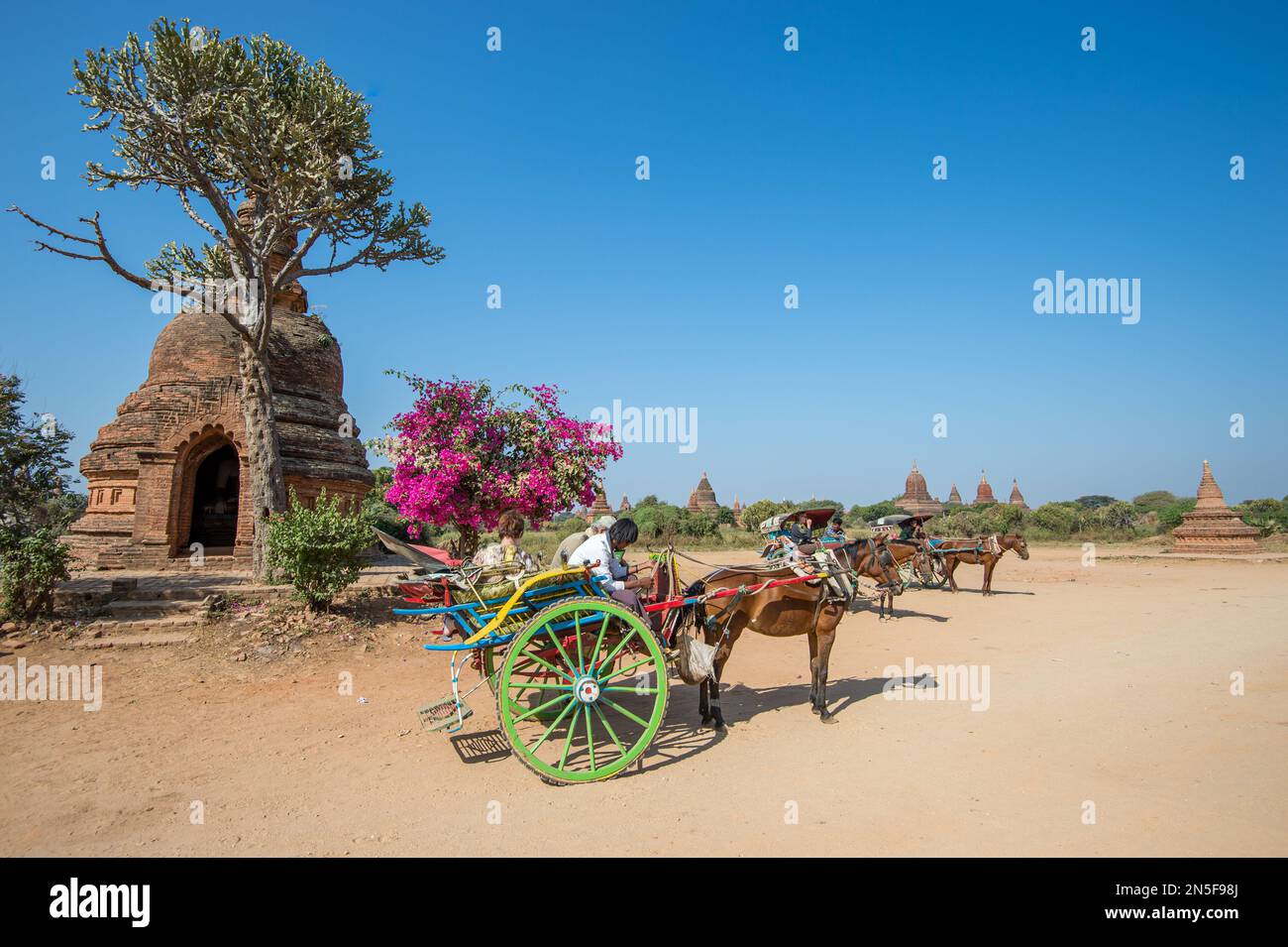Tourists explore the archeological sites at Bagan on traditional two