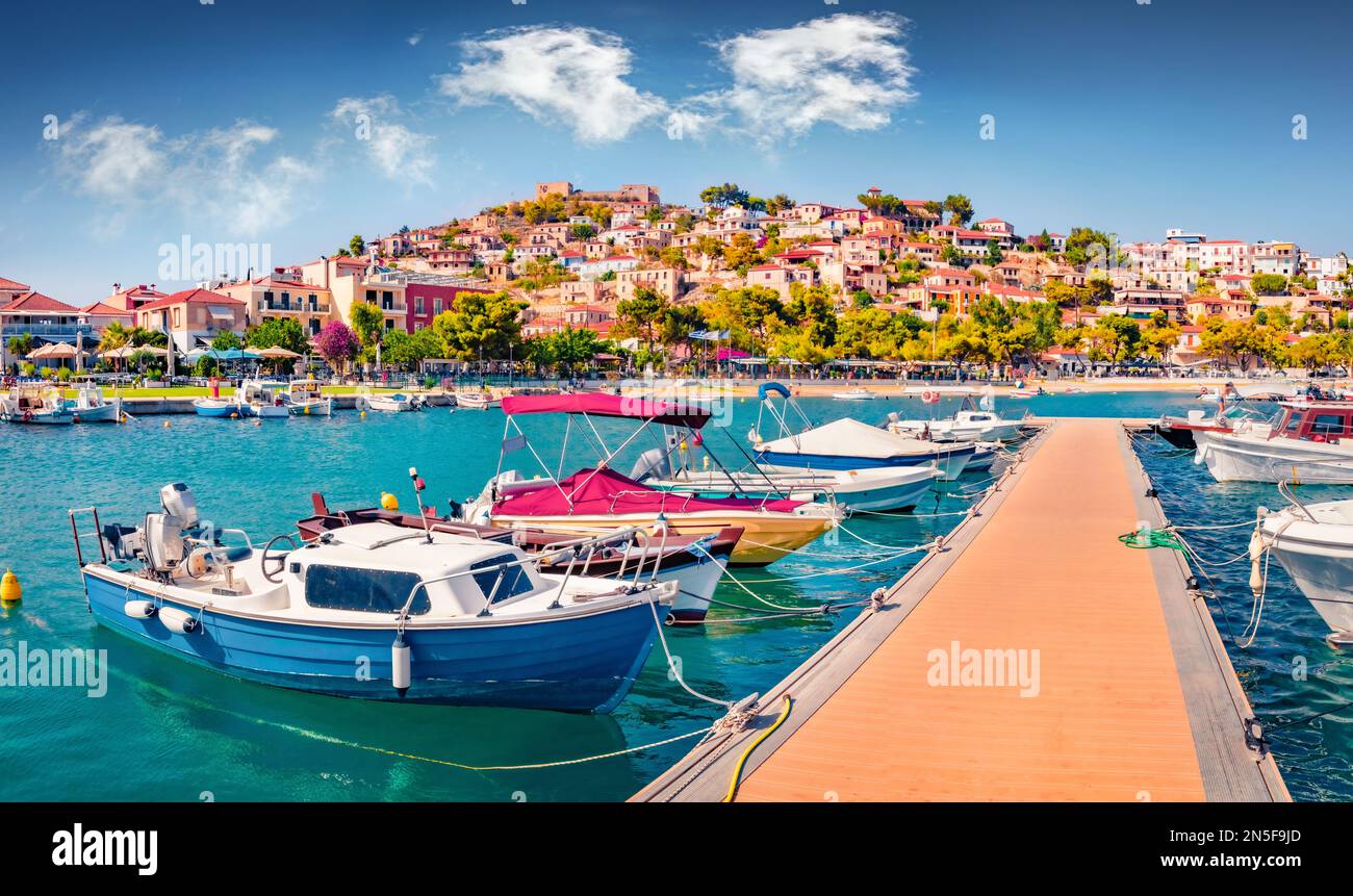 Sunny summer  view of Astros port. Wonderful morning seascape of Myrtoan Sea. Picturesque urban scene of Arcadia region, Greece, Europe. Traveling con Stock Photo