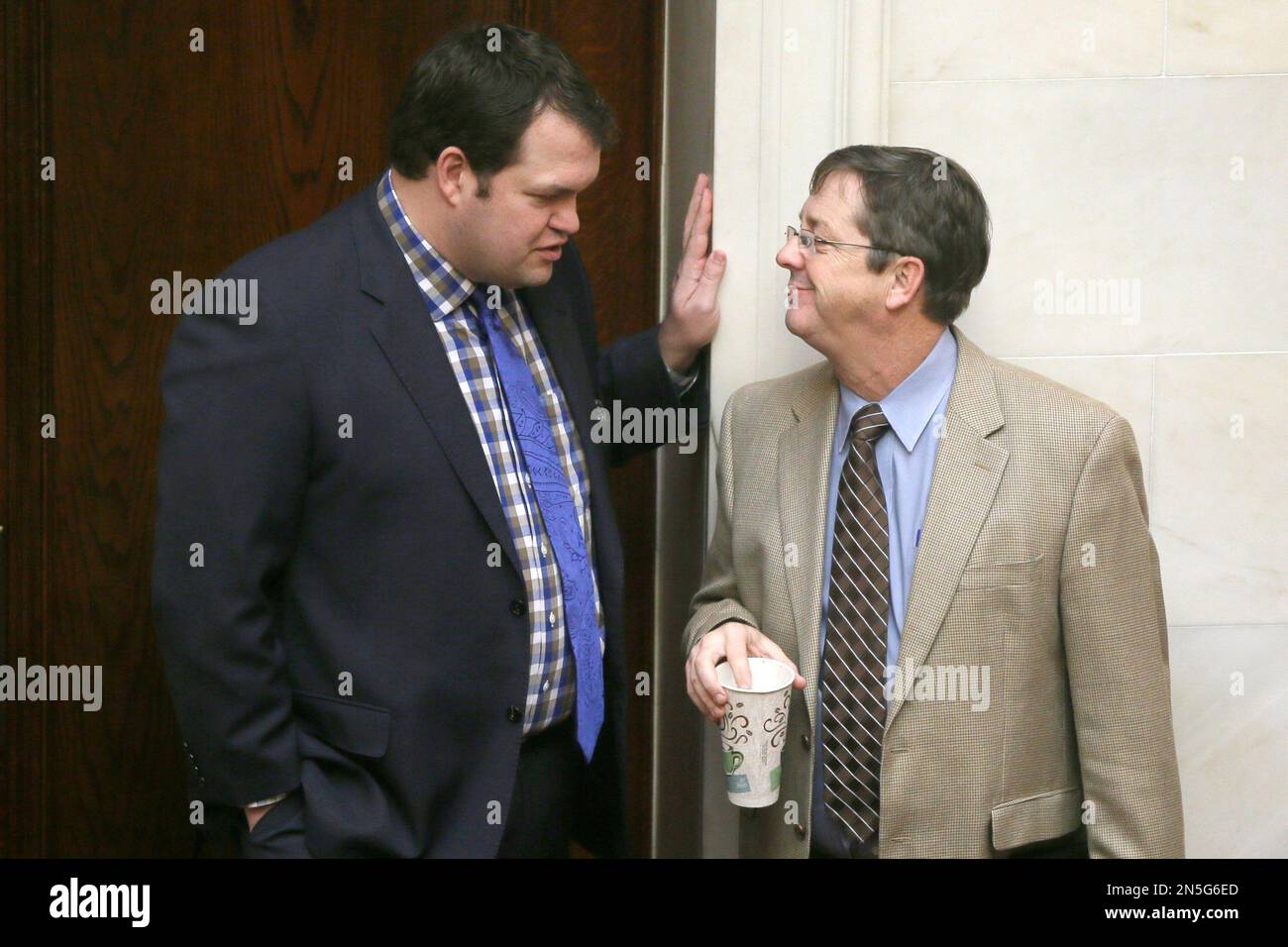 Senate President Michael Lamoureux, RRussellville, left, speaks with Sen. Larry Teague, D