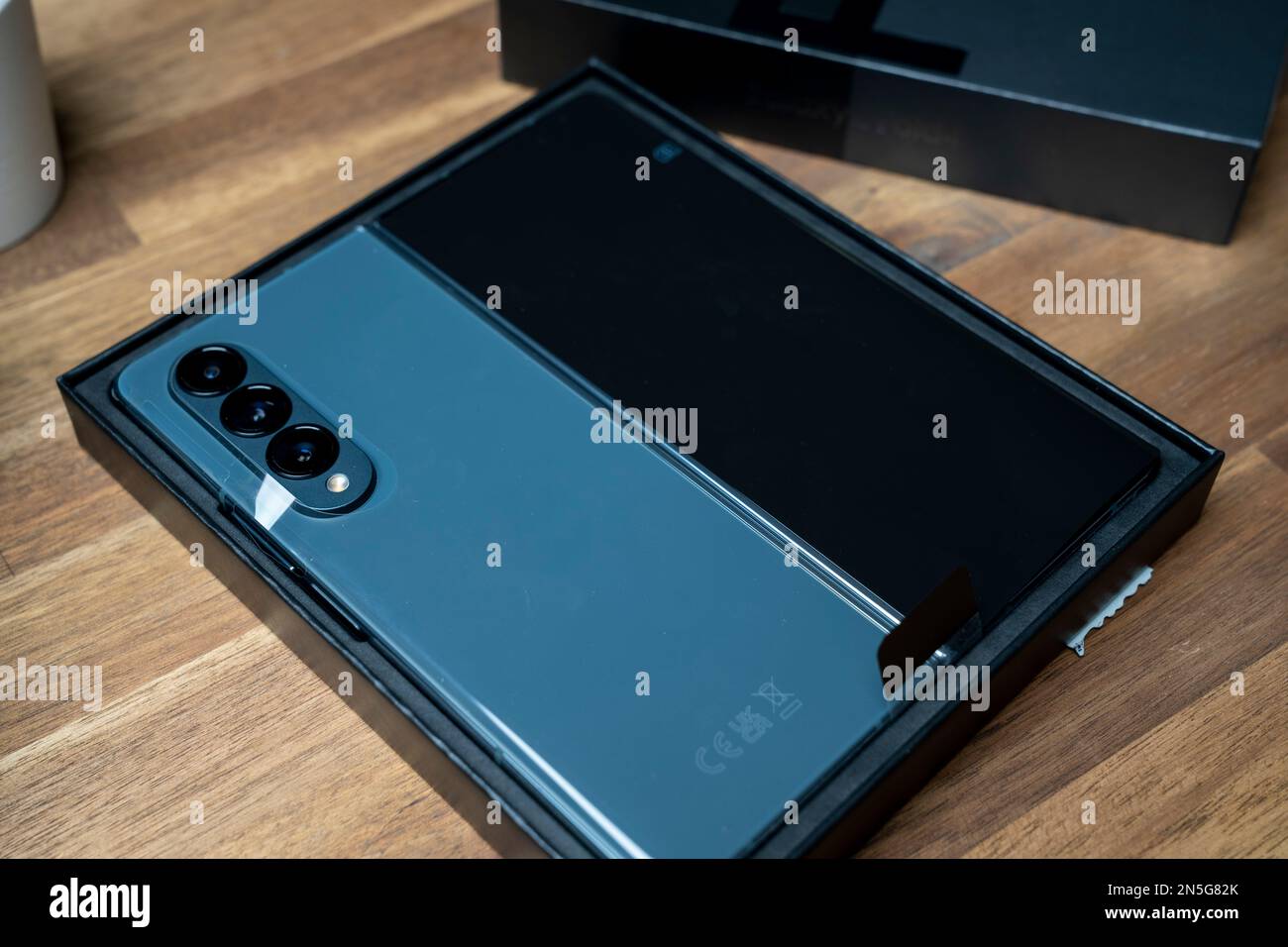Brand new Samsung Galaxy Z Fold 4 in grey-green color. The device is in the  open position. Original box on the side Stock Photo - Alamy