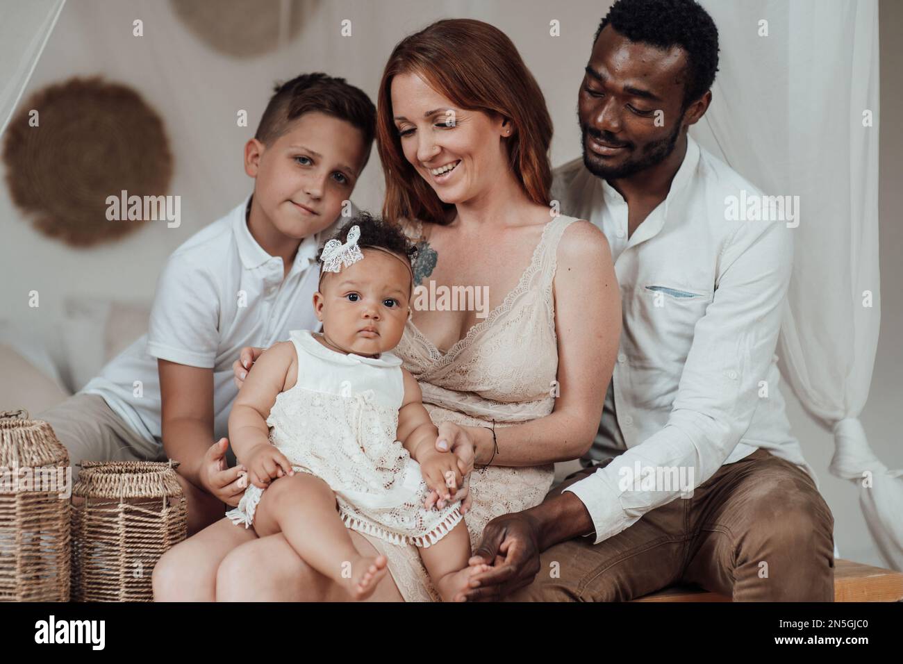 Mixed race family with white son and infant swarthy daughter spend time