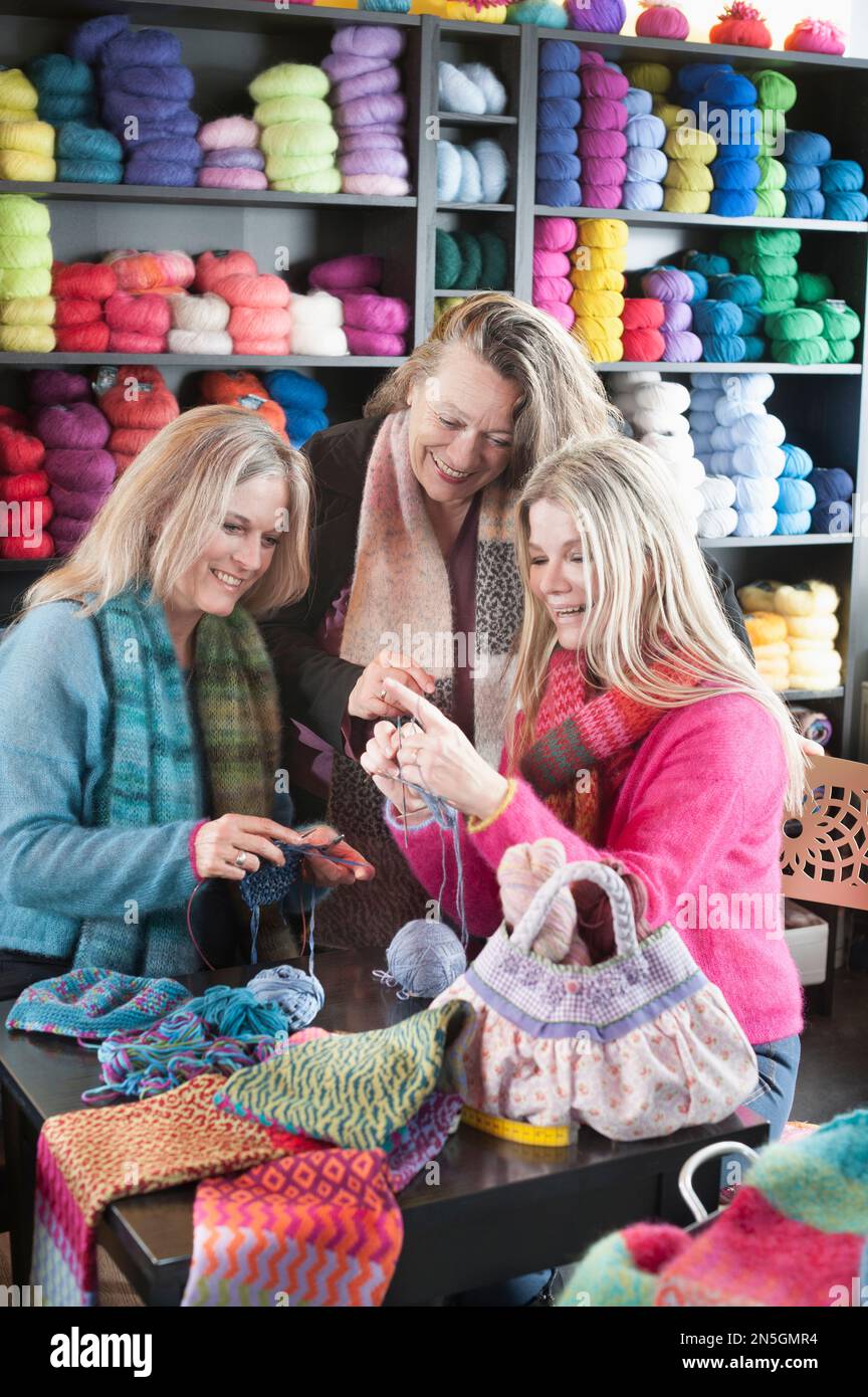 Knitting teacher with two women in knitting lesson, Bavaria, Germany