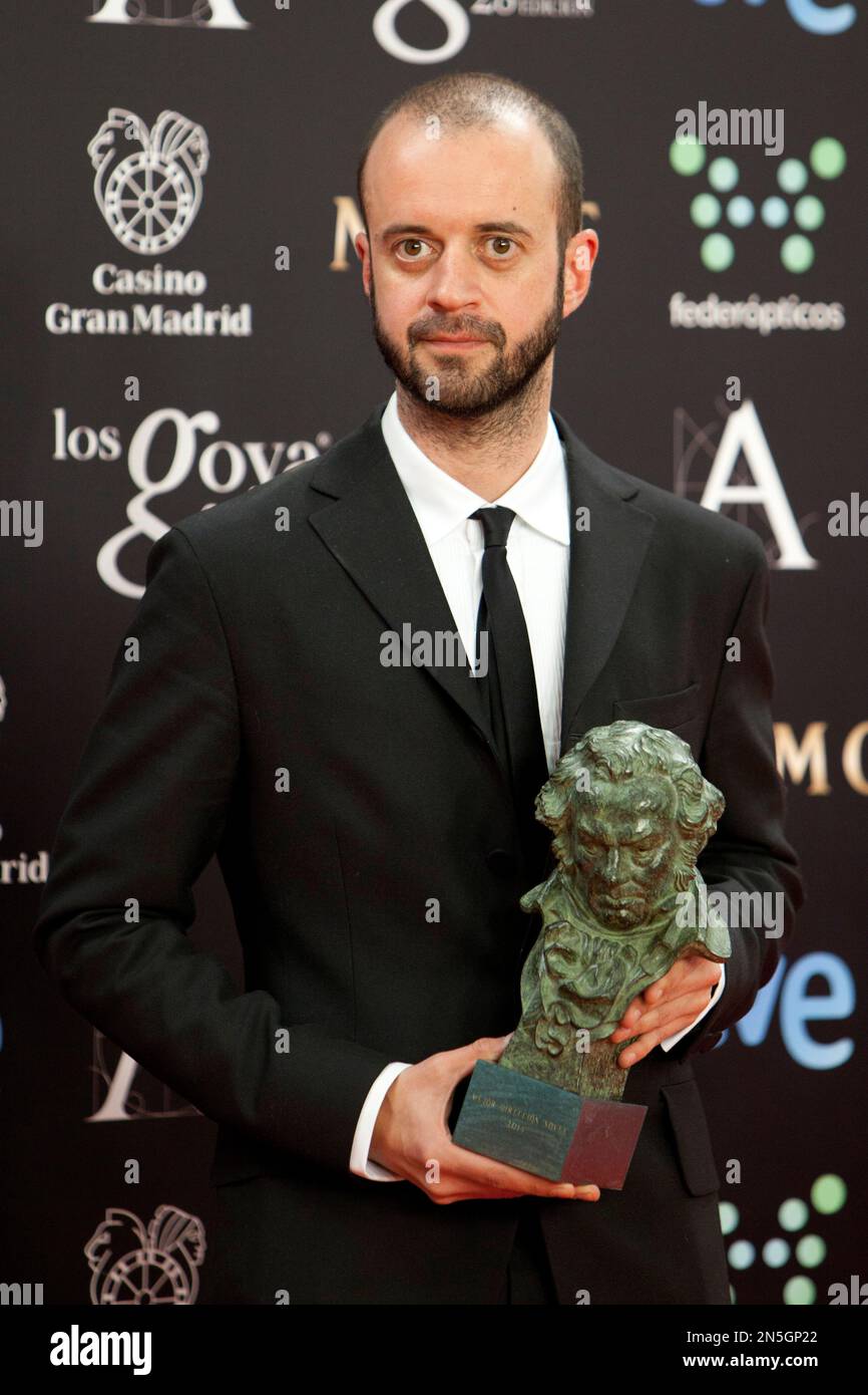 Spanish director Fernando Franco holds his Goya trophy after winning ...