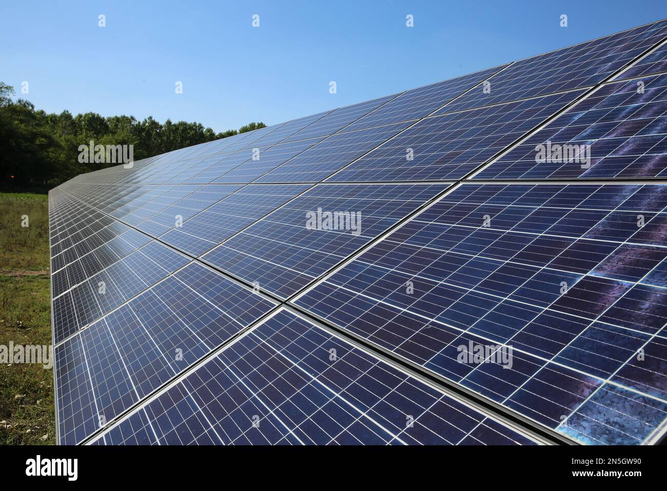 Line of solar power plant panels. Renewable energy. Solar plant panel for green energy power. Stock Photo