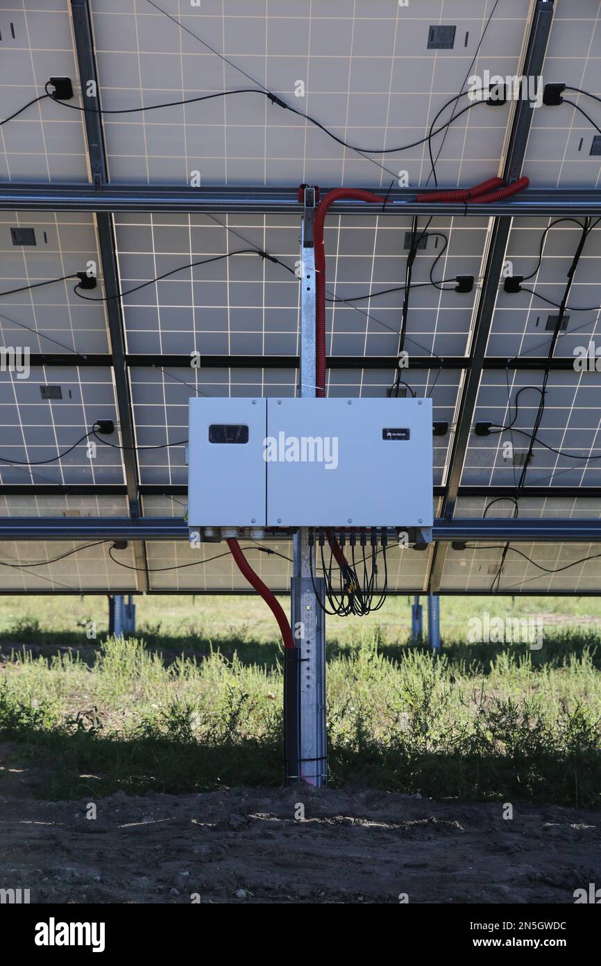 Inverter behind the solar panels. Renewable energy. Solar plant panel for green energy power. Stock Photo