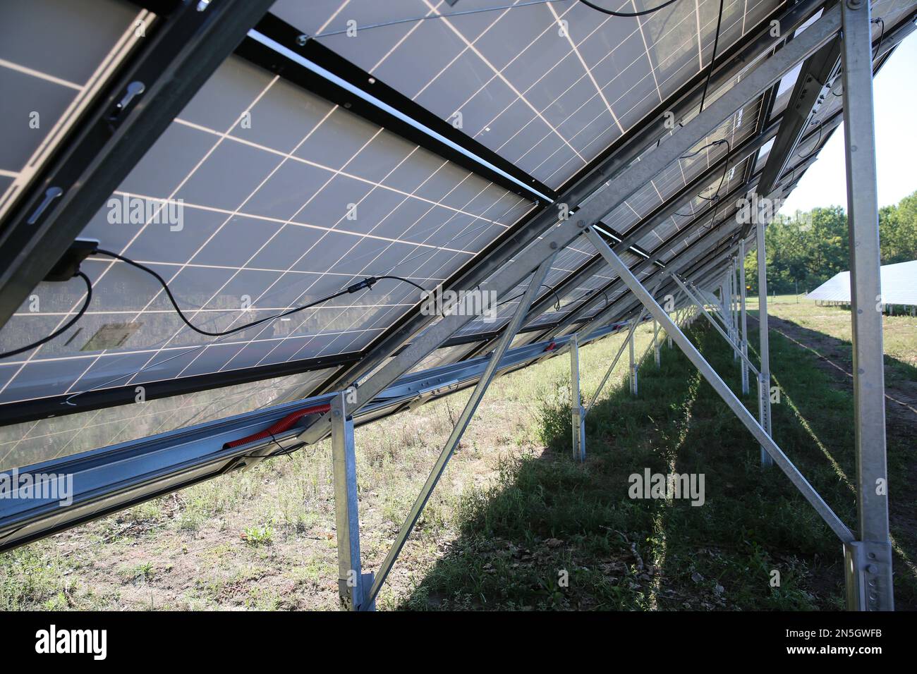 Behind the solar panels. Renewable energy. Solar plant panel for green energy power. Stock Photo