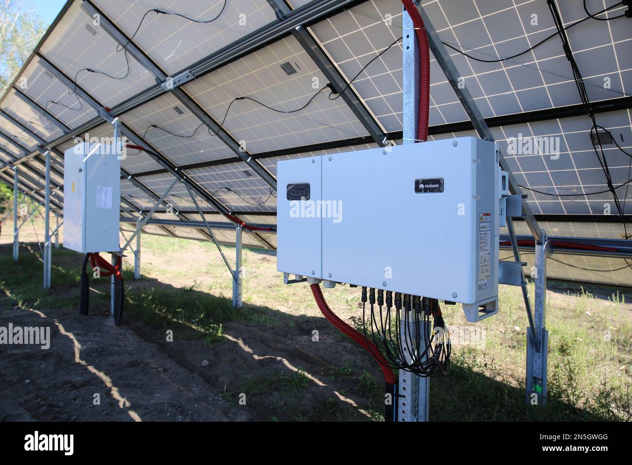 Inverter behind the solar panels. Renewable energy. Solar plant panel for green energy power. Stock Photo