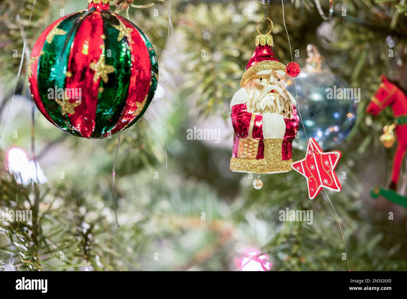 Christmas baubles and snowman hanging on Christmas tree, Munich, Germany Stock Photo