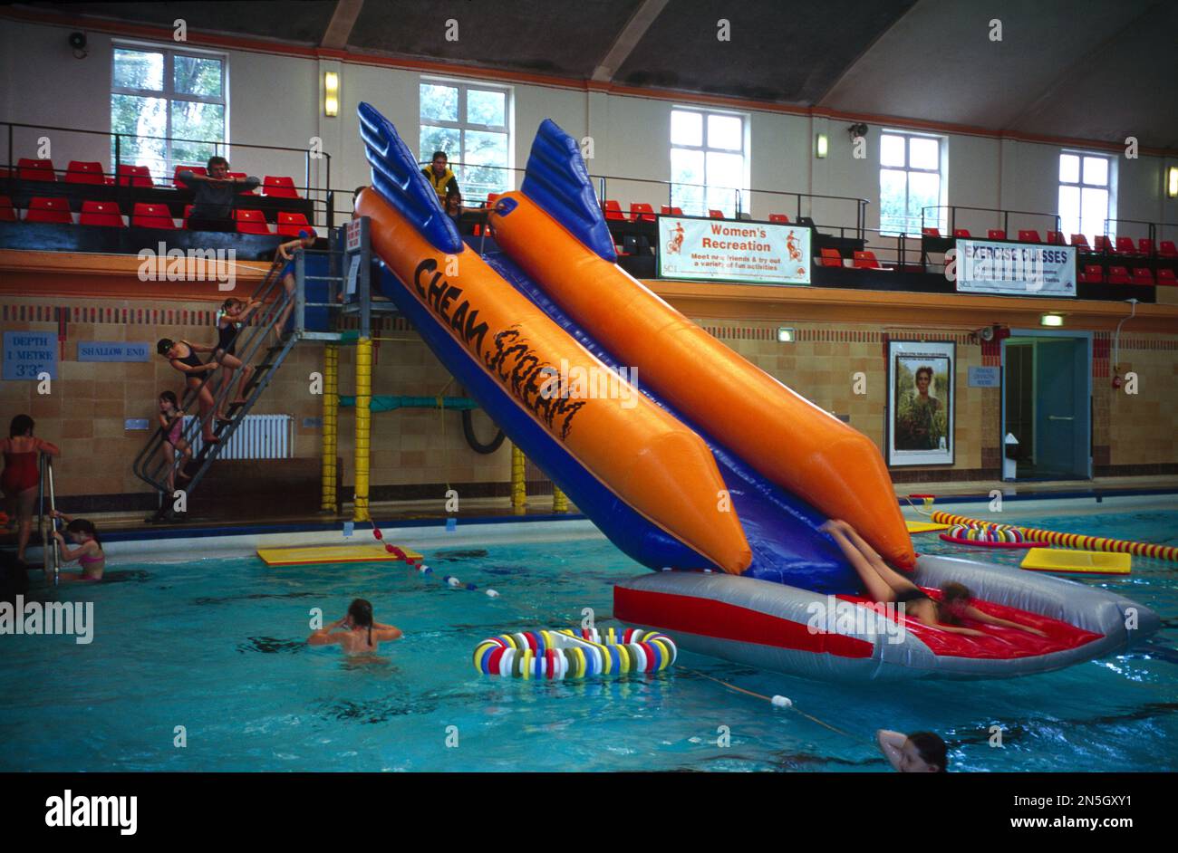 Children At Swimming Pool Party with Inflatables and Slide Surrey