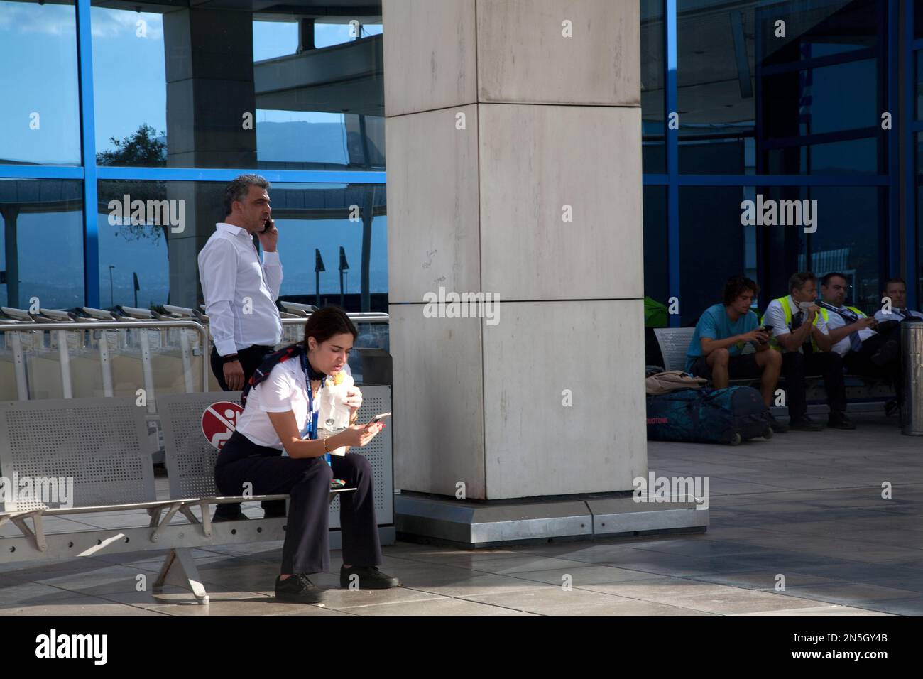 airport employee with mobile phone athens international airport sparta