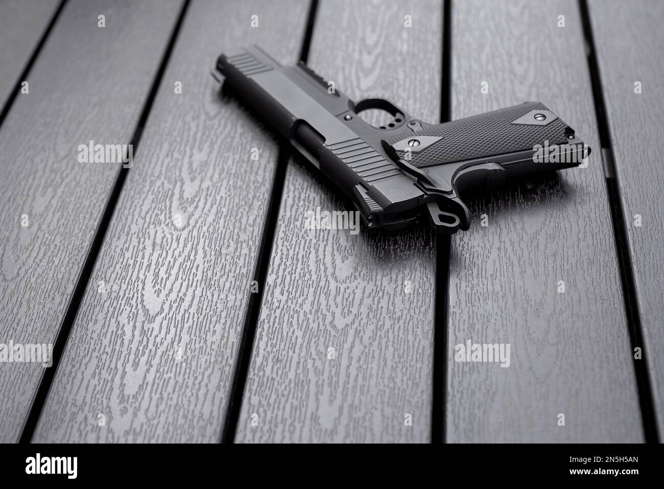 Classic airsoft gun placed on a dark wooden board Stock Photo Alamy