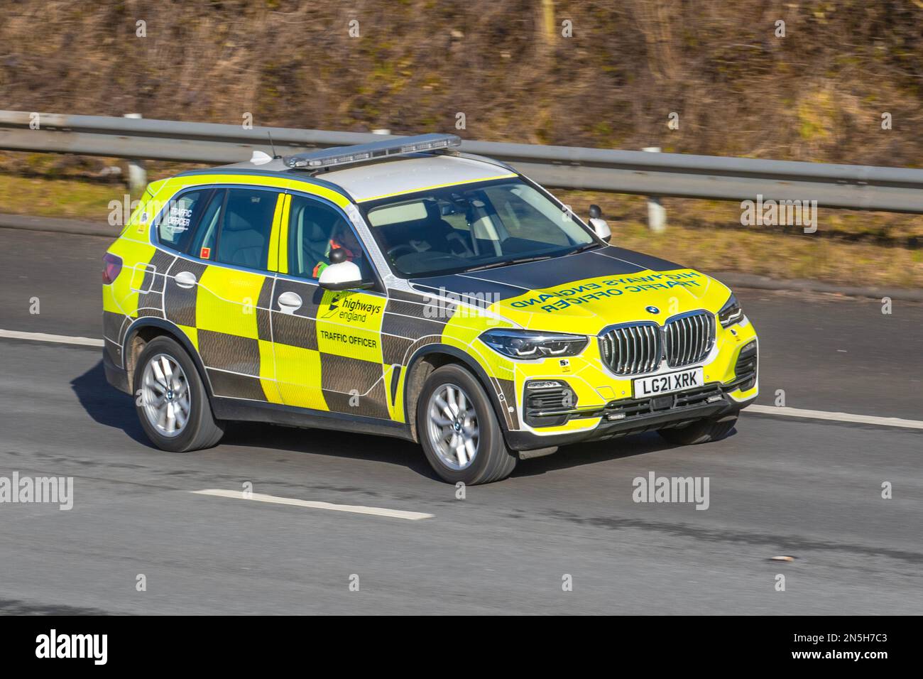 National Highways Agency female Traffic Officer driving BMW X5 Xdrive45E XLine Auto SUV patrol vehicle; travelling on the M6 Motorway, UK Stock Photo