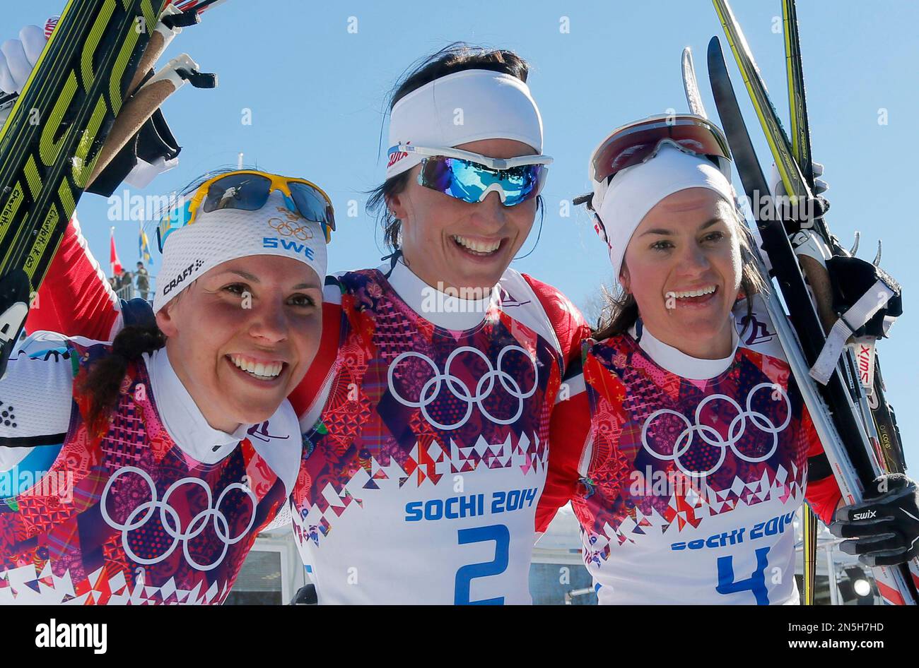 Norway's gold medal winner Marit Bjoergen is flanked by Sweden's silver