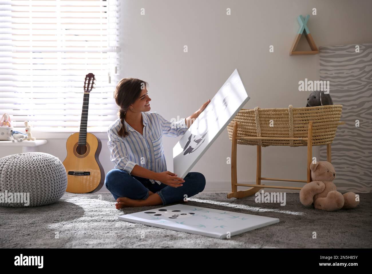 Decorator with pictures on floor in baby room. Interior design Stock ...