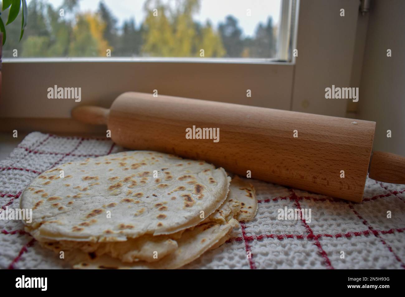 Stack of thin flatbread lavash on a wooden serving board Stock Photo
