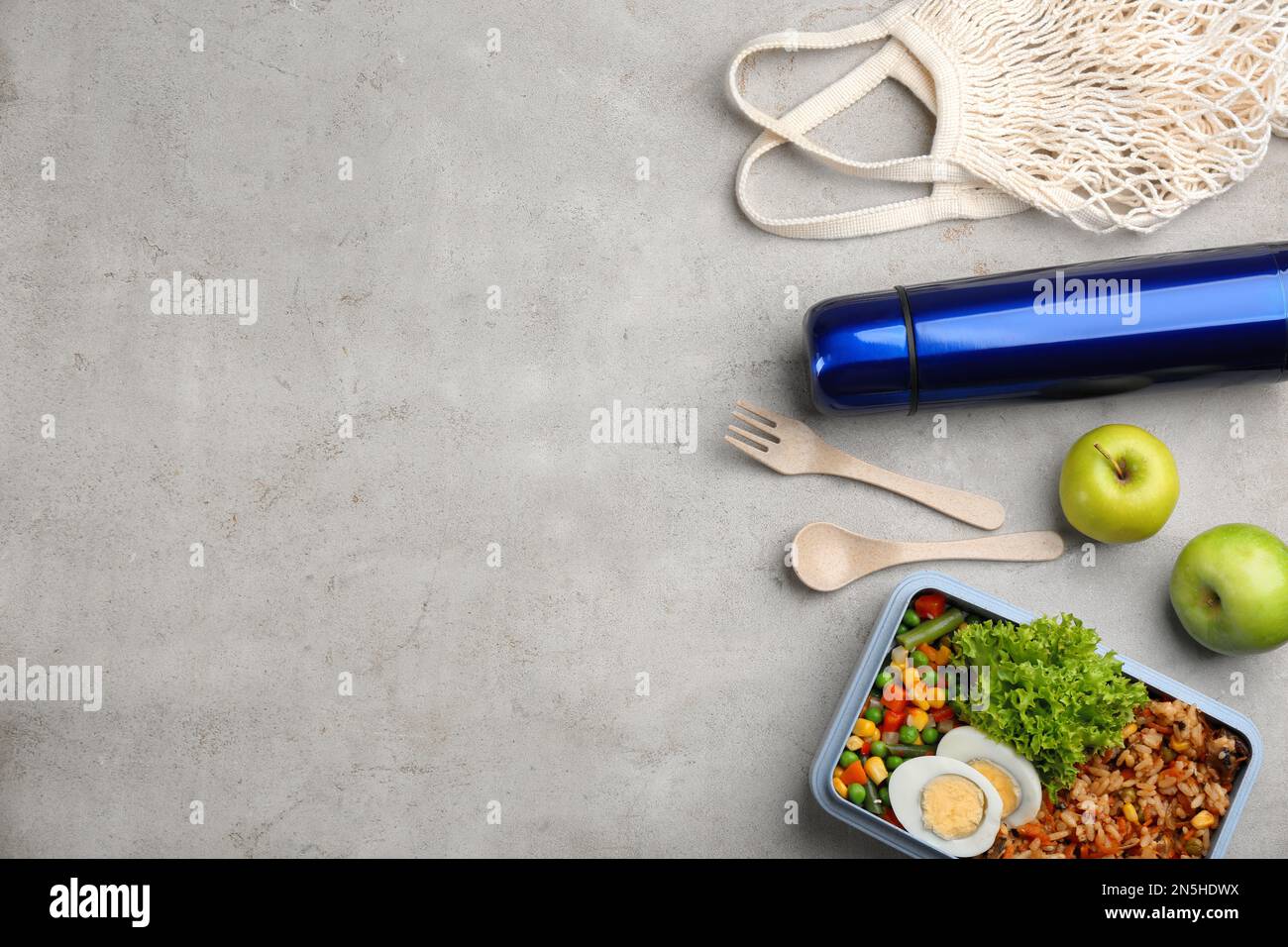 Flat lay composition with thermos and food on light grey table. Space ...