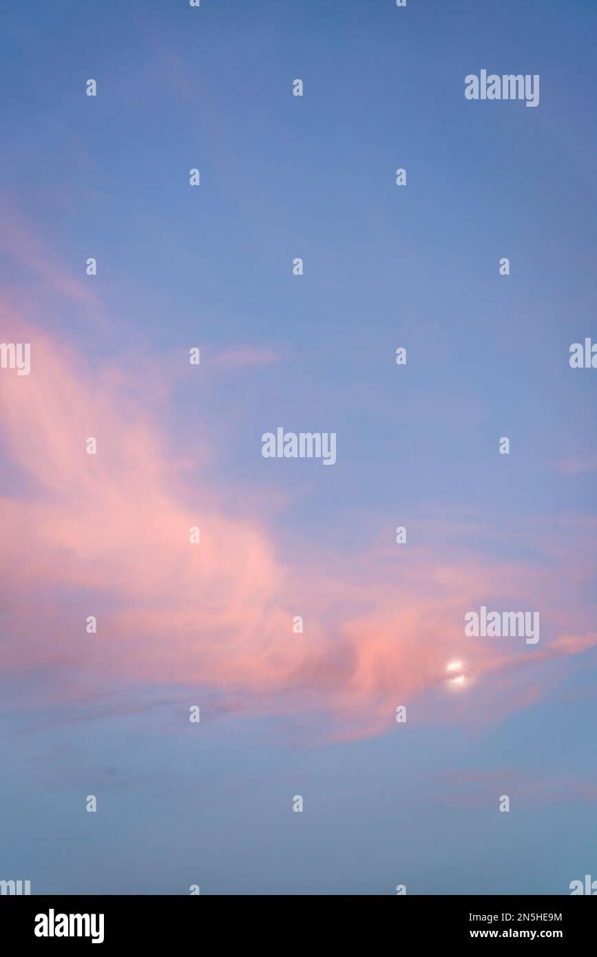 Pink cloudscape with the Moon Stock Photo