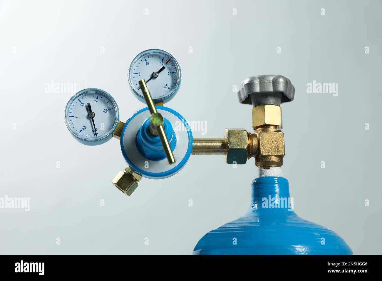Pressure gauge of medical oxygen tank on light grey background, closeup