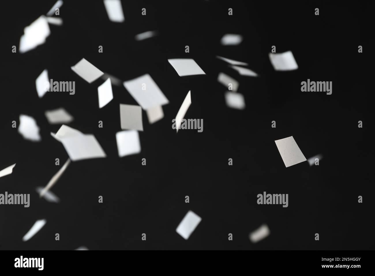 White confetti falling down on black background Stock Photo Alamy