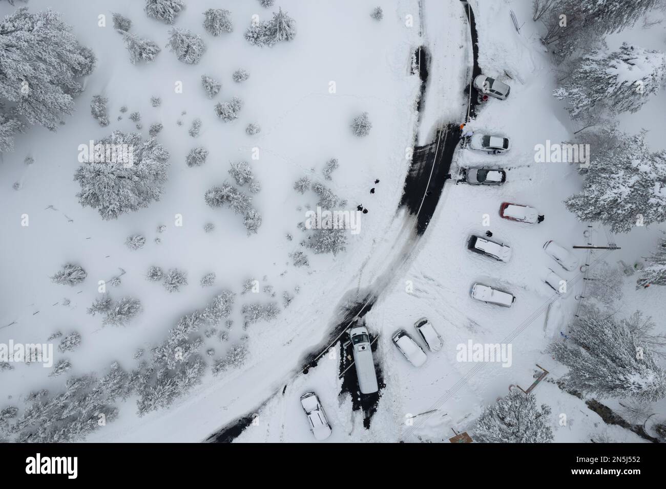 Drone scenery of car vehicles covered in snow on parked on a frozen ...