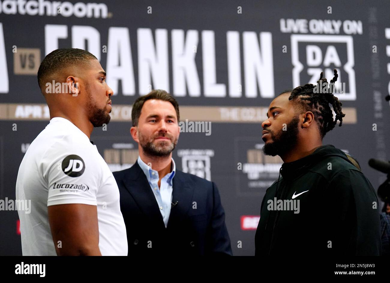 Promoter Eddie Hearn stands in the centre as Anthony Joshua (left) and Jermaine Franklin face off during a press conference at the Hilton London Syon Park. The Heavyweight clash between Joshua and Franklin will take place at The O2 on Saturday April 1. Picture date: Thursday February 9, 2023. Stock Photo