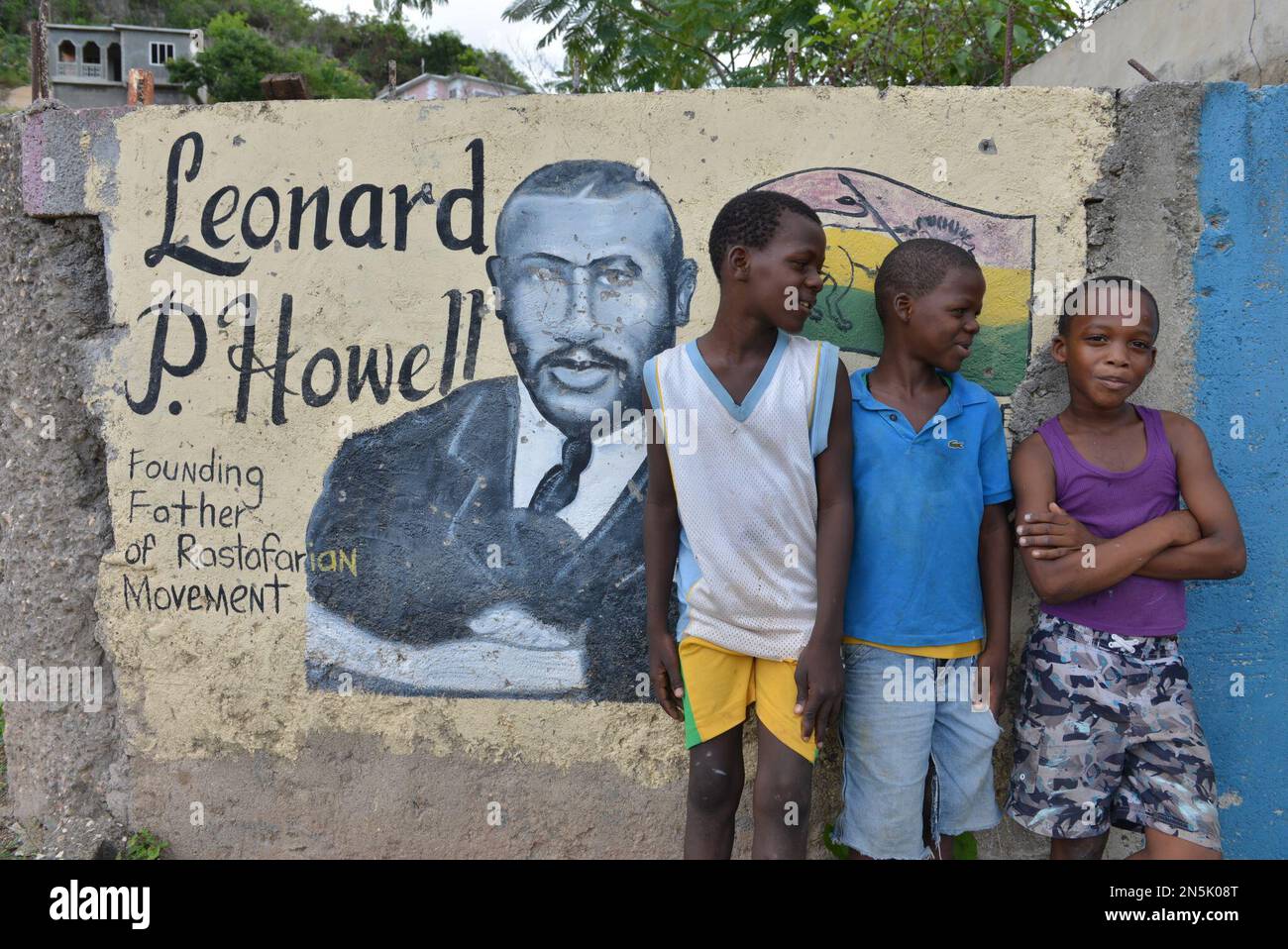 In this Jan. 4, 2014 photo, students pose for a photo by a mural of