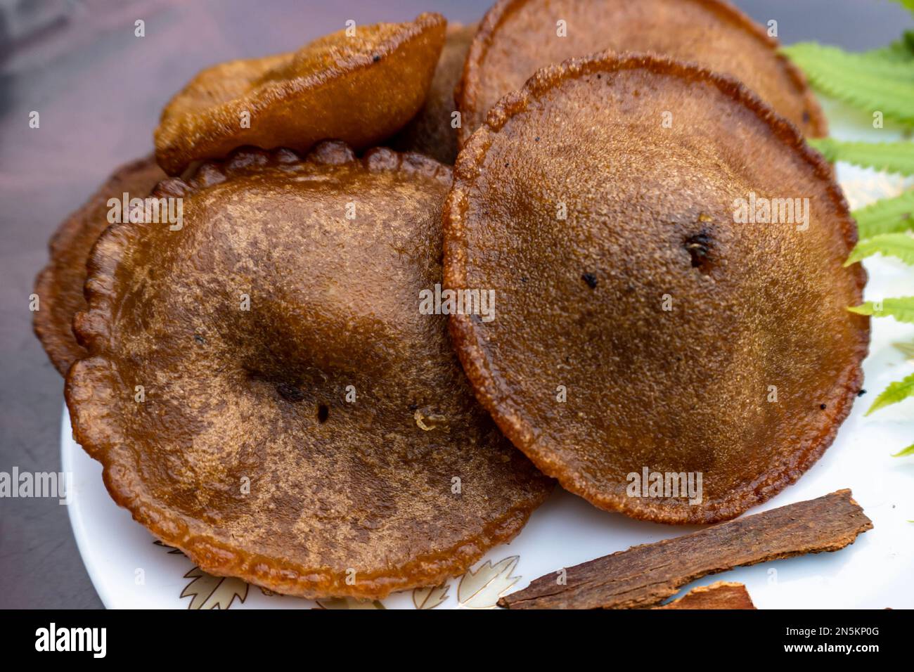 Oily cake is a popular food in Bangladesh and by Indian people. Oil cake is made from rice with oil, which is called tele pitha in Bangladesh. Stock Photo