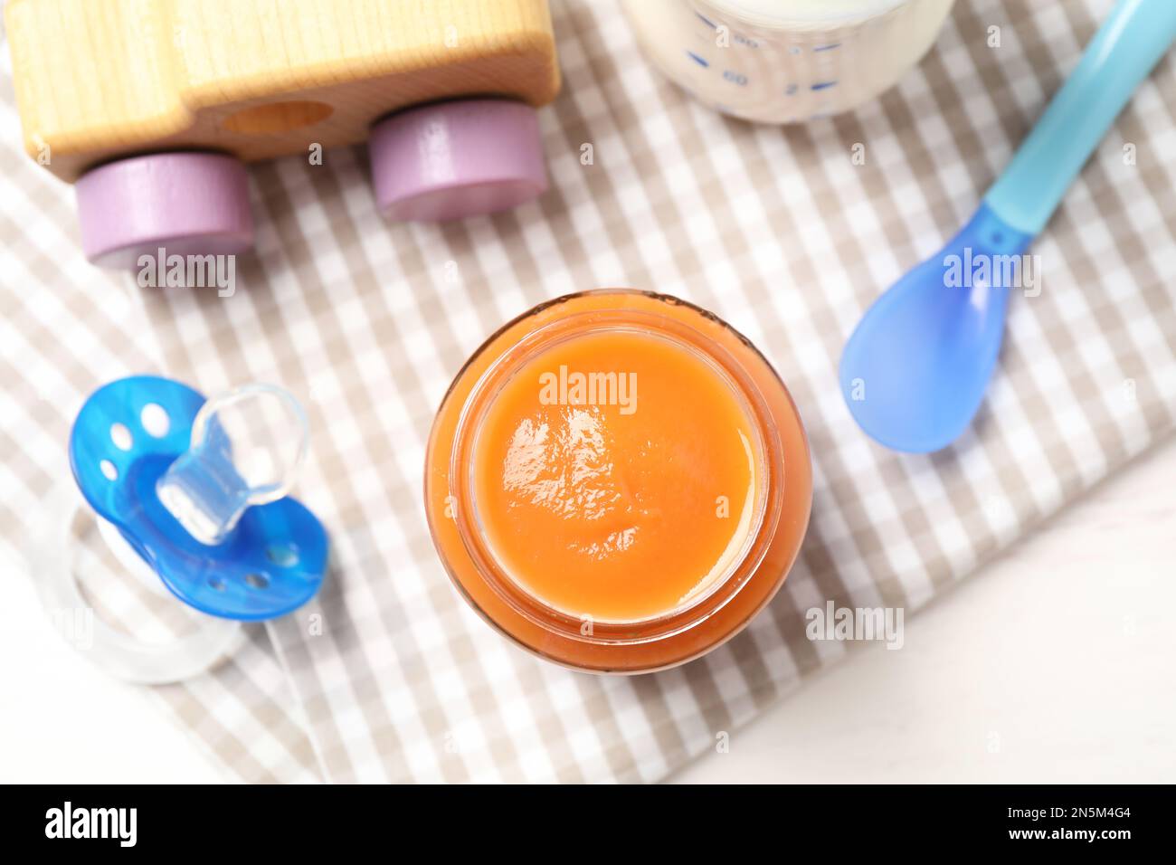 Flat lay composition with baby food and accessories on white background  Stock Photo - Alamy