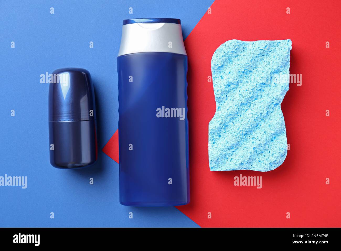 Men's personal hygiene products and shower sponge on color background
