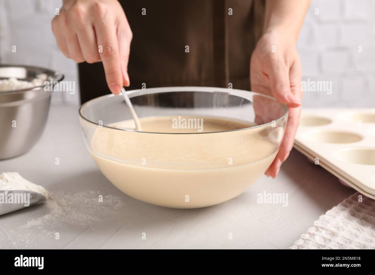 Woman making batter at light table, closeup Stock Photo - Alamy